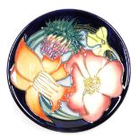 A Moorcroft pottery pin dish, floral decorated on a blue ground, to commemorate the Golden Jubilee o