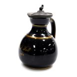 A mid 19thC Jackfield type pottery jug, with a spurriet weighted hinged pewter lid, the black body g