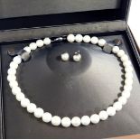 A string of uniform cultured pearls, on a silver snap clasp, by Sherry Jewellery, boxed, together wi