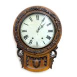 A Victorian oak cased circular wall clock, carved with acorns and oak leaves, circular dial bearing
