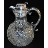 A Victorian silver and cut glass claret jug, with a silver handle, mount and hinged lid, embossed wi