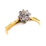 A diamond solitaire ring, high claw set in white and yellow metal, stamped 18ct, approximately 0.6ct