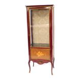 A 20thC Continental display cabinet, the top with a moulded edge above a glazed door flanked by two