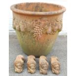 A terracotta planter, with fruit and bloom swags, and four terracotta lion planter raisers, 46cm hig