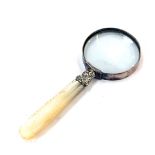 A mother of pearl handled magnifying glass, with a silver collar, 12cm long.