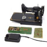 A Singer portable electric sewing machine, number 221K, with instruction booklet, lead, and various