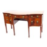 A George III mahogany and boxwood inlaid serpentine fronted sideboard, with central frieze drawer, f