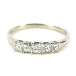 An 18ct white gold and diamond dress ring, set with five square cut diamonds, each in claw setting,