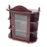 A mahogany wall cabinet, a central glazed door flanked by three open compartments, 52cm high, 41cm w