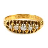 An 18ct gold diamond gypsy ring, old cut diamonds each in claw setting, with scroll design shoulders