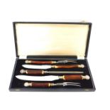 A Pinder Brothers of Sheffield white metal and fawn handled presentation carving set, with silver co