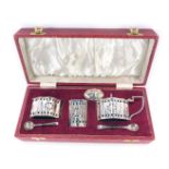 A Elizabeth II silver three piece cruet set, of pierced design with central star, comprising two pre