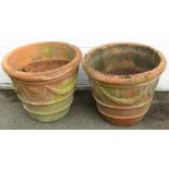 A pair of substantial terracotta planters, each with a floral and wheat swag, 54cm high, 66cm diamet