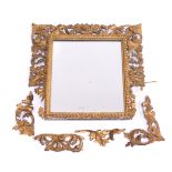 A Florentine giltwood gesso rectangular wall mirror, with a foliate scroll frame, within beaded bord