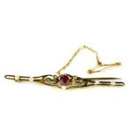 A Victorian bar brooch, set with central garnet and seed pearls on single pin back, with safety chai