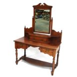 An Edwardian walnut dressing table, the swing frame mirror above a shaped drawer compartment, the ba