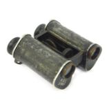 A pair of late 20thC binoculars, inscribed SNLY1987, in metal outer casing, 12cm deep.
