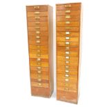 A pair of early 20thC oak filing cabinets, each with eighteen drawers, with plated brass handles, 20