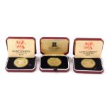 Three silver proof commemorative coins, comprising two Montgomery 1976 crowns, and a 22ct gold plate