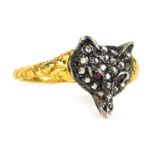 A fox dress ring, the shaped fox's head set with tiny diamonds and two ruby eyes, in white metal on