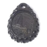 A jet carved pendant, the pendant with mountainous scene, 5cm high.