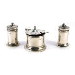 A George V silver cased three piece cruet set, comprising salt and pepper, mustard, two later spoons