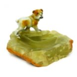 An onyx ashtray, mounted with a bulldog, 15cm diameter.