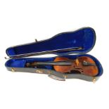 A late 19th/early 20thC two piece split back violin, 56cm long, with bow, in fitted case.