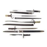 Five bayonets, comprising a Turkish Mauser, a French Lebel, an Israeli Mauser, a 1907 WSG, and anoth