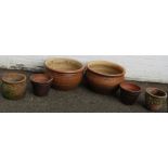 A collection of planters, comprising two reconstituted stone and terracotta glazed planters, 27cm hi