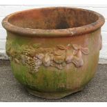 A terracotta planter, with fruits and bloom swags, 41cm high, 60cm diameter.
