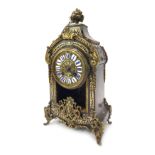 A 19thC French Boulle mantel clock, the brass circular dial with blue painted enamel Roman numerals,