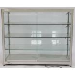 A glass fronted shop display cabinet, with four tiered shelves, 100cm high, 120cm wide, 50cm deep.