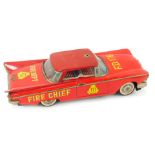 A tinplate friction driven Oldsmobile labelled fire chief.