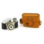 A Minetta miniature spy camera, in leather case, camera 5.5cm wide.