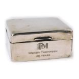 A George V silver cigarette box, of plain design with fitted wooden interior, bearing initials S F M