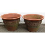 Two modern terracotta planters, each with a scrolled and leaf design on outer fluted border, 35cm hi