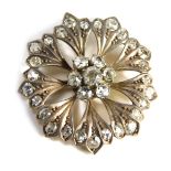 A diamond flower brooch, the central cluster of diamonds forming a flower, the central stone approx