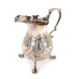 A George II silver cream jug, with later engraved duck and cockerel decoration, with shield bearing