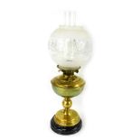 A late 19th/early 20thC brass oil lamp, with a clear and frosted glass shade, brass central reservoi