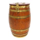 A 19thC oak and coopered barrel, the top with a hinged lid with brass mounts, enclosing a vacant int