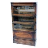 An oak Globe Wernicke bookcase, the top with three glass fronted sections above a cupboard with draw
