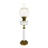 A late 19th/early 20thC oil lamp, with a frosted and clear glass shade, clear glass central reservoi