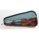 A two piece split back violin, bearing label for Karel Pilar, Houslar, V Hrad cl Kral.R.19, with bow