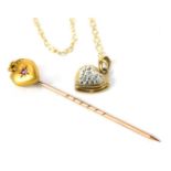 A small group of jewellery, comprising a 9ct gold topped stick pin, the heart set with garnet, and a