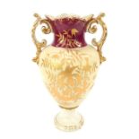 A 19thC pottery two handled vase, of baluster form, decorated with gilt heightened flowers and leave