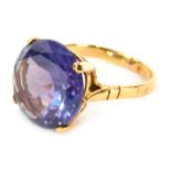 A multifaceted mystic topaz ring, round brilliant cut in four claw raised basket setting, with etche