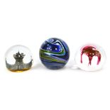 Three glass paperweights, comprising Isle of Wight glass striped weight, Caithness Marrakesh 245/500