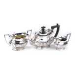 A George V silver three piece tea set, comprising teapot, two handled sugar bowl and milk jug, each