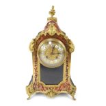 A 19thC French Boulle mantel clock, the circular embossed brass face with raised white enamel Roman